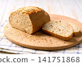 loaf of freshly wheat bread with sourdough on white kitchen table. 141751868