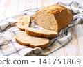loaf of artisan bread or traditional wheat rustic bread on white kitchen table. 141751869