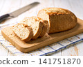 Artisan bread or traditional wheat rustic bread on white kitchen table, selective focus. 141751870