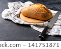 Artisan bread or traditional wheat rustic bread on dark kitchen table, selective focus. 141751871