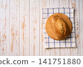 loaf of wheat bread with sourdough with ears of wheat on white kitchen table, copy space for text. Top view. 141751880