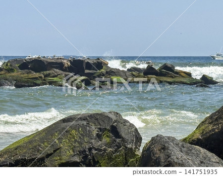 Close up of Beach Rocks and Waves at Asbury Park in New Jersey Close up of Beach Rocks and Waves at Asbury Park in New Jersey 141751935