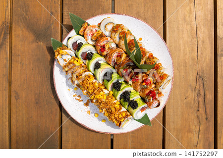 Assorted gourmet sushi roll set with salmon, tuna, shrimp, avocado, black and red caviar Assorted gourmet sushi roll set with salmon, tuna, shrimp, avocado, black and red caviar 141752297