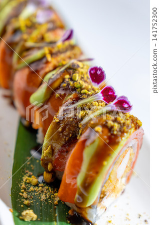 Top view of gourmet sushi roll with salmon, avocado, fried shrimp and cream cheese Top view of gourmet sushi roll with salmon, avocado, fried shrimp and cream cheese 141752300