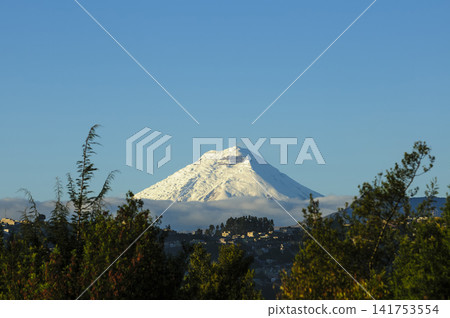 Majestic Snow-Capped Cotopaxi Volcano at Sunrise from Quito, Ecuador. Majestic Snow-Capped Cotopaxi Volcano at Sunrise from Quito, Ecuador. 141753554