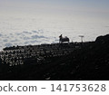 A mountain hut floating in a sea of clouds 141753628