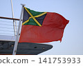 Jamaican civil ensign flag waving on a yacht under blue sky Jamaican civil ensign flag waving on a yacht under blue sky 141753933