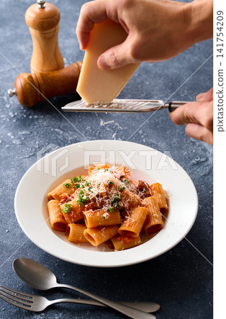 Rigatoni with Bolognese sauce and cheese Rigatoni with Bolognese sauce and cheese 141754209