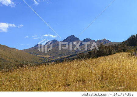 Panoramic view of the peaks of the extinct Pasochoa volcano from its eastern slopes in the Andes Mountains, Ecuador, under a clear blue sky Panoramic view of the peaks of the extinct Pasochoa volcano from its eastern slopes in the Andes Mountains, Ecuador, under a clear blue sky 141754392