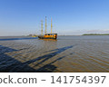 Wooden tourist boat sailing on the Guayas River on a clear day in Guayaquil, Ecuador 141754397