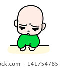A toddler making a face when being scolded 141754785
