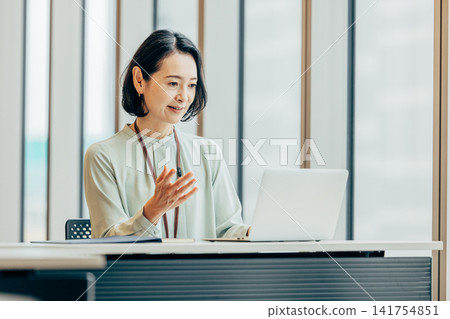 Business woman heading to PC at office Business woman heading to PC at office 141754851