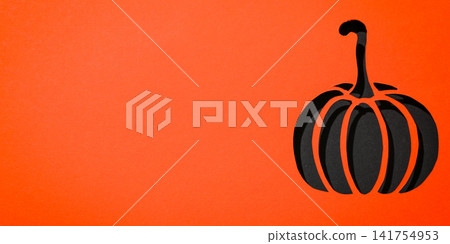 Halloween. Black pumpkin cutout showcases Halloween spirit in vibrant orange backdrop Halloween. Black pumpkin cutout showcases Halloween spirit in vibrant orange backdrop 141754953