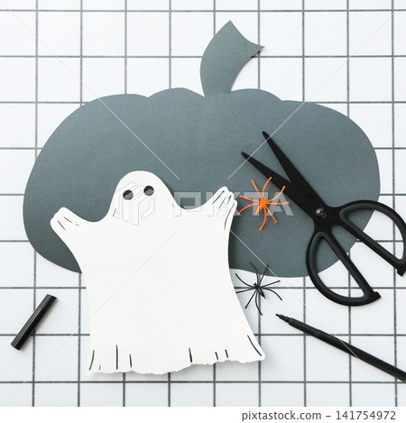 Halloween background. Kids create fun Halloween decorations with paper cutouts Halloween background. Kids create fun Halloween decorations with paper cutouts 141754972