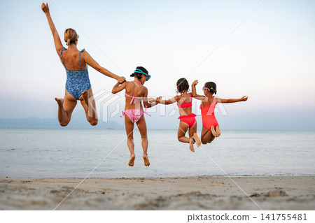 Mother and daughters enjoying summer beach vacation in Greece Mother and daughters enjoying summer beach vacation in Greece 141755481