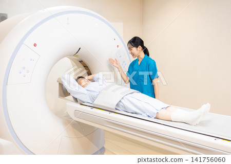 Patient undergoing a CT scan and radiologist. Photo courtesy of Denpa Gakuen Educational Foundation, Tokyo Electronics College. Patient undergoing a CT scan and radiologist. Photo courtesy of Denpa Gakuen Educational Foundation, Tokyo Electronics College. 141756060