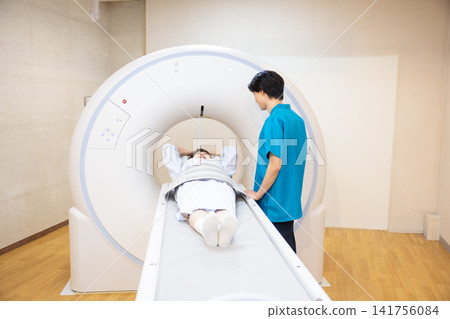 患者正在接受CT掃描,放射科醫師也在場。照片由東京電子大學電波學園教育基金會提供。 患者正在接受CT掃描,放射科醫師也在場。照片由東京電子大學電波學園教育基金會提供。 141756084