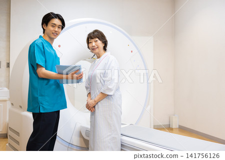 Patient undergoing a CT scan and radiologist. Photo courtesy of Denpa Gakuen Educational Foundation, Tokyo Electronics College. Patient undergoing a CT scan and radiologist. Photo courtesy of Denpa Gakuen Educational Foundation, Tokyo Electronics College. 141756126