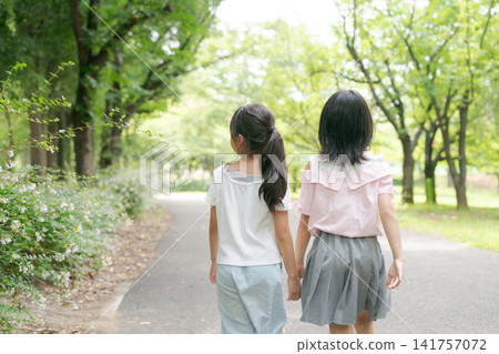 A child walking hand in hand A child walking hand in hand 141757072
