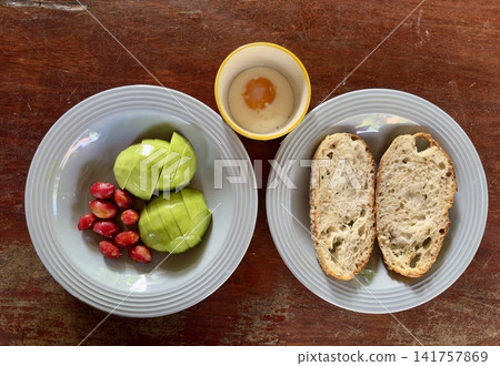 Close up view of delicious rustic sourdough toast with fresh avocado, cherry tomatoes and egg on a wooden table Close up view of delicious rustic sourdough toast with fresh avocado, cherry tomatoes and egg on a wooden table 141757869