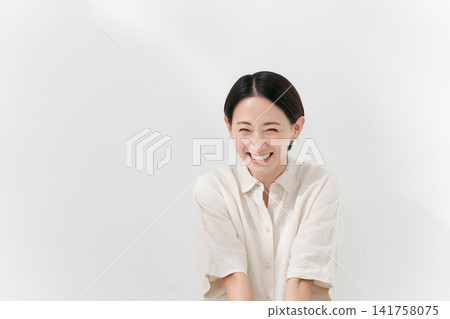 Smiling woman in her 30's Smiling woman in her 30's 141758075