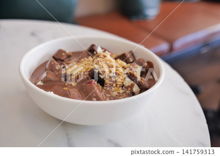 Chocolate dessert bowl with toppings on a table Chocolate dessert bowl with toppings on a table 141759313