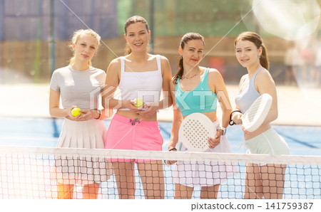 Women standing near the net on the court Women standing near the net on the court 141759387