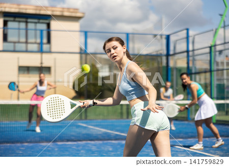 Woman on the court playing paddle tennis Woman on the court playing paddle tennis 141759829