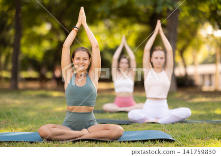 Group of young women doing yoga in lotus pose Group of young women doing yoga in lotus pose 141759830