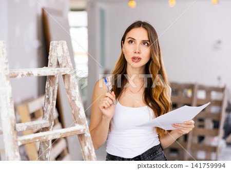 Woman construction manager checking project documentation Woman construction manager checking project documentation 141759994