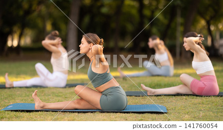 Group of young women doing yoga in park Group of young women doing yoga in park 141760054