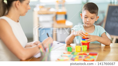 Little boy arranging stacking cups during psychological test Little boy arranging stacking cups during psychological test 141760087
