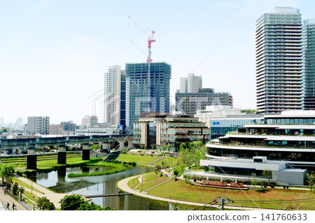 Apartment buildings and a pond Apartment buildings and a pond 141760633