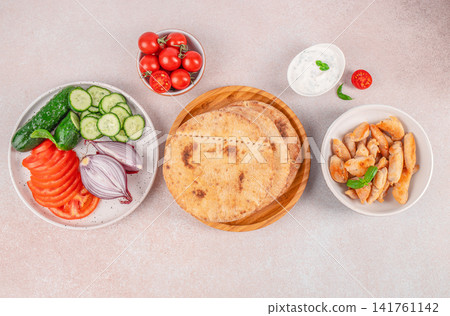 Mediterranean Pita Bread with Chicken and Fresh Vegetables 141761142