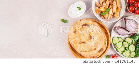 Mediterranean Pita Ingredients with Chicken and Copy Space Mediterranean Pita Ingredients with Chicken and Copy Space 141761143