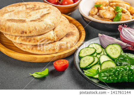 Mediterranean Pita Bread with Chicken and Fresh Vegetables Mediterranean Pita Bread with Chicken and Fresh Vegetables 141761144