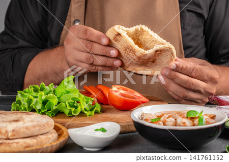 Chef Preparing Pita Pocket with Chicken and Vegetables 141761152