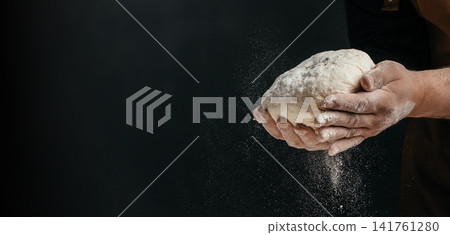 Baker holding artisan dough with flour dust and copy space Baker holding artisan dough with flour dust and copy space 141761280