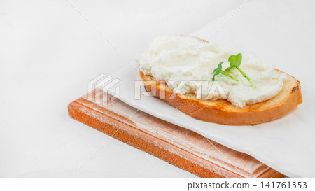 Cream cheese toast with microgreens on white background and copy space Cream cheese toast with microgreens on white background and copy space 141761353