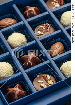 Assorted Luxury Chocolates in Blue Gift Box Close Up Assorted Luxury Chocolates in Blue Gift Box Close Up 141761395