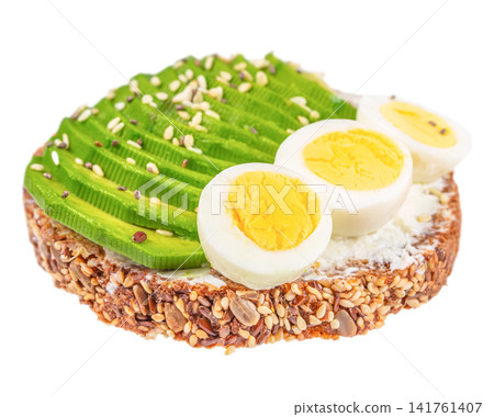 Avocado toast with boiled egg on seeded bread isolated on white background Avocado toast with boiled egg on seeded bread isolated on white background 141761407