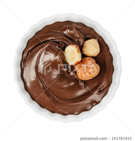 Chocolate hazelnut spread with whole hazelnuts isolated on white background top view Chocolate hazelnut spread with whole hazelnuts isolated on white background top view 141761425