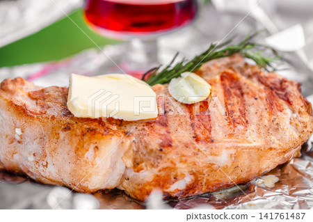 Grilled pork steak with butter garlic and rosemary close up Grilled pork steak with butter garlic and rosemary close up 141761487