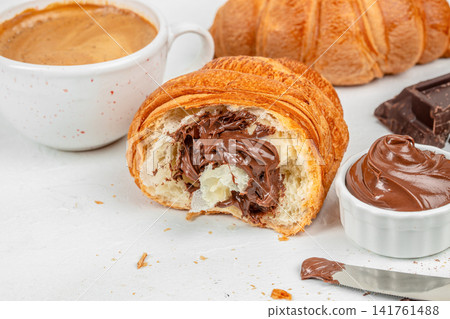 Chocolate Filled Croissant with Coffee and Hazelnut Spread for Breakfast Chocolate Filled Croissant with Coffee and Hazelnut Spread for Breakfast 141761488