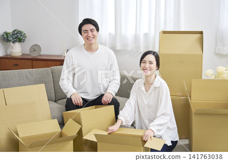 Moving house: A couple in front of cardboard boxes - Portrait Moving house: A couple in front of cardboard boxes - Portrait 141763038