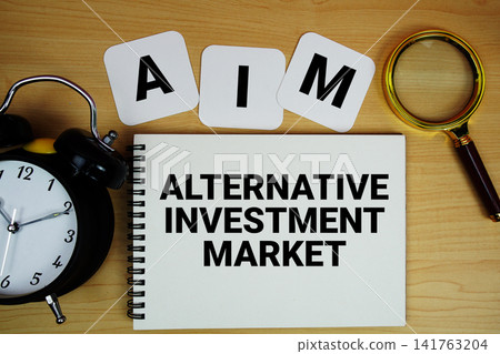 AIM Alternative Investment Market text written on notepad with magnifying glass and alarm clock on wooden background AIM Alternative Investment Market text written on notepad with magnifying glass and alarm clock on wooden background 141763204