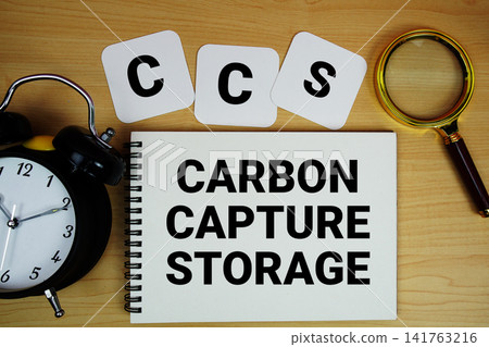 CCS Carbon Capture Storage text written on notepad with magnifying glass and alarm clock on wooden background CCS Carbon Capture Storage text written on notepad with magnifying glass and alarm clock on wooden background 141763216