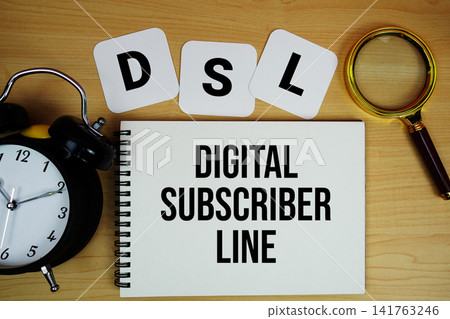 DSL Digital Subscriber Line text written on notepad with magnifying glass and alarm clock on wooden background DSL Digital Subscriber Line text written on notepad with magnifying glass and alarm clock on wooden background 141763246