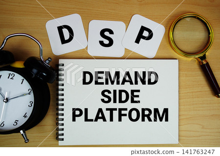 DSP Demand Side Platform text written on notepad with magnifying glass and alarm clock on wooden background DSP Demand Side Platform text written on notepad with magnifying glass and alarm clock on wooden background 141763247