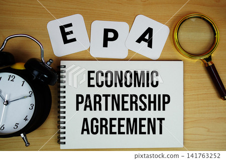 EPA Economic Partnership Agreement text written on notepad with magnifying glass and alarm clock on wooden background EPA Economic Partnership Agreement text written on notepad with magnifying glass and alarm clock on wooden background 141763252